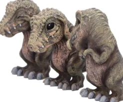 Drei weise T-Rex Figuren: Nichts sehen, nichts hören, nichts sagen